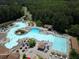Captivating aerial perspective of a resort-style swimming pool featuring a lazy river, water slides, and ample deck space at 3022 Woodbridge Ln, Canton, GA 30114
