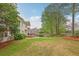 Lush backyard offers serene landscaping, complete with a spacious grassy area and a charming patio perfect for outdoor enjoyment at 3022 Woodbridge Ln, Canton, GA 30114