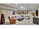 Finished basement featuring a cozy seating area with a large sectional and sports decor at 3022 Woodbridge Ln, Canton, GA 30114