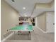 Spacious finished basement with a ping pong table and comfortable seating area at 3022 Woodbridge Ln, Canton, GA 30114