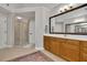 Bathroom with a large mirror, wooden vanity, and glass enclosed shower at 3022 Woodbridge Ln, Canton, GA 30114