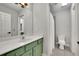 Bright bathroom featuring an olive green vanity, and neutral tile flooring at 3022 Woodbridge Ln, Canton, GA 30114
