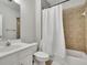 Bright bathroom with a tub and shower combo featuring tile surround and a white vanity at 3022 Woodbridge Ln, Canton, GA 30114