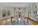 Bright dining area featuring contemporary lighting, floor to ceiling windows, and backyard views at 3022 Woodbridge Ln, Canton, GA 30114