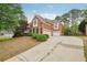 A brick home with a driveway, a garage, and manicured landscaping in a suburban setting at 3022 Woodbridge Ln, Canton, GA 30114