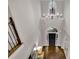 Grand foyer boasts a high ceiling, modern chandelier, arched window, and elegant hardwood flooring at 3022 Woodbridge Ln, Canton, GA 30114