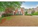 Charming brick home featuring well-manicured landscaping and classic architectural details at 3022 Woodbridge Ln, Canton, GA 30114