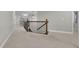Upstairs hallway featuring neutral carpet, wood railing, and decorative wrought iron spindles at 3022 Woodbridge Ln, Canton, GA 30114