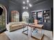 Elegant home office space featuring built-in shelving, contemporary lighting, and large windows at 3022 Woodbridge Ln, Canton, GA 30114
