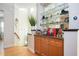 Stylish bar area with custom cabinets, granite countertops, and a mirrored backsplash at 5888 Riverstone Cir # 15, Atlanta, GA 30339