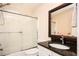 Bathroom with granite-topped vanity and a shower-tub combo with glass doors at 5888 Riverstone Cir # 15, Atlanta, GA 30339