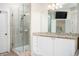 Bathroom featuring glass enclosed shower, granite countertop, and a large mirror at 5888 Riverstone Cir # 15, Atlanta, GA 30339