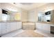 Bright bathroom with double sinks, vanities, granite countertops, tiled floors, and soaking tub at 5888 Riverstone Cir # 15, Atlanta, GA 30339