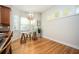 Sun-drenched breakfast nook with bay windows, wood floors, stylish lighting, and seating for two at 5888 Riverstone Cir # 15, Atlanta, GA 30339