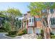 Beautiful brick townhouse with a two-car garage, bay window, and manicured landscaping on a sunny day at 5888 Riverstone Cir # 15, Atlanta, GA 30339