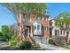 Stunning brick townhouse with a two-car garage, bay window, and a manicured front garden at 5888 Riverstone Cir # 15, Atlanta, GA 30339