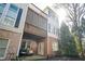 Exterior view of the home with a screened-in deck and a brick patio below, offering outdoor living at 5888 Riverstone Cir # 15, Atlanta, GA 30339