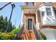 Inviting front entrance with brick steps, wrought iron railing, and a covered porch with white columns at 5888 Riverstone Cir # 15, Atlanta, GA 30339