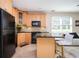 Kitchen with wooden cabinets, black appliances, and granite countertops at 5888 Riverstone Cir # 15, Atlanta, GA 30339