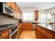 Well-equipped kitchen with stainless steel appliances, granite countertops, and wooden cabinets at 5888 Riverstone Cir # 15, Atlanta, GA 30339