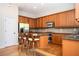 Bright kitchen with stainless steel appliances, hardwood floors, granite counters, and central island with barstool seating at 5888 Riverstone Cir # 15, Atlanta, GA 30339