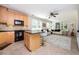 Kitchen with wood cabinets, island with seating, and open to living area at 5888 Riverstone Cir # 15, Atlanta, GA 30339