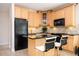 Kitchen with wooden cabinets, black appliances, and granite countertops at 5888 Riverstone Cir # 15, Atlanta, GA 30339