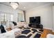 Bright living room with large windows, hardwood floors, and stylish decor at 5888 Riverstone Cir # 15, Atlanta, GA 30339