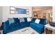 Comfortable living room showcasing a plush blue sectional sofa with nailhead trim and stylish decor at 5888 Riverstone Cir # 15, Atlanta, GA 30339