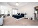 Spacious primary bedroom boasts tray ceilings, carpet, a bed with a marble headboard, and an en suite bathroom at 5888 Riverstone Cir # 15, Atlanta, GA 30339