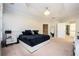 Spacious main bedroom boasts tray ceilings, carpet, a bed with a marble headboard, and an en suite bathroom at 5888 Riverstone Cir # 15, Atlanta, GA 30339