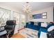 Bright office space with natural light, modern lighting fixture, a comfortable blue sofa, and hardwood floors at 5888 Riverstone Cir # 15, Atlanta, GA 30339