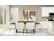 Bright dining room with table, white chairs, large artwork, and sliding glass doors at 120 Sunny Side Way, Acworth, GA 30102