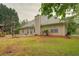 Exterior view of home with a lovely backyard and statue at 1917 Kevin Dr, Conyers, GA 30013