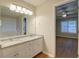 Well-lit bathroom features a double sink vanity with granite countertops, and a separate tub and shower at 1917 Kevin Dr, Conyers, GA 30013