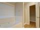 Bright bathroom featuring a soaking tub with a large window and a separate shower area at 1917 Kevin Dr, Conyers, GA 30013