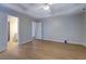 Spacious bedroom featuring beautiful floors, a ceiling fan, and an ensuite bathroom at 1917 Kevin Dr, Conyers, GA 30013
