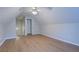 Attic bedroom with vaulted ceiling, wood-look flooring, and a ceiling fan at 1917 Kevin Dr, Conyers, GA 30013