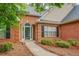 Welcoming front entrance with a white door, sidelights, and a pathway leading to the home at 1917 Kevin Dr, Conyers, GA 30013