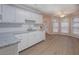 Bright kitchen with white cabinets, granite countertops, and a view of the backyard at 1917 Kevin Dr, Conyers, GA 30013