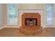 Living room featuring a brick fireplace, large windows, and a door to the backyard at 1917 Kevin Dr, Conyers, GA 30013