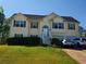 Inviting two-story home with a well-manicured front lawn and attached two-car garage at 204 Millpond Pkwy, Villa Rica, GA 30180