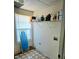 Functional laundry room with a window, shelf, and ample storage space at 204 Millpond Pkwy, Villa Rica, GA 30180