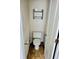Compact powder room featuring a toilet, toilet paper holder, and towel rack at 204 Millpond Pkwy, Villa Rica, GA 30180