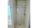 Bathroom shower with white tile and fixtures in a well-lit bathroom at 204 Millpond Pkwy, Villa Rica, GA 30180