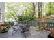A spacious back deck surrounded by lush greenery and trees perfect for outdoor enjoyment at 205 Wellesley Ct, Woodstock, GA 30189