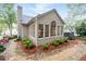 The home's back exterior features a sunroom with many windows overlooking the backyard at 205 Wellesley Ct, Woodstock, GA 30189