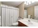 Bathroom features a shower curtain, a toilet, and a cherry vanity with sink at 205 Wellesley Ct, Woodstock, GA 30189