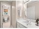 Bright bathroom featuring a white marble vanity and view of the toilet through doorway at 205 Wellesley Ct, Woodstock, GA 30189