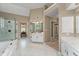Bright bathroom with a garden tub, glass enclosed shower and separate vanities at 205 Wellesley Ct, Woodstock, GA 30189